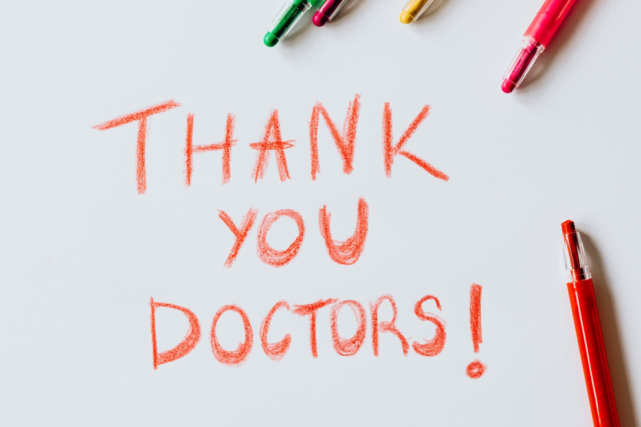 Mastering the First Impression: Your intriguing post title goes here A handwritten 'Thank You Doctors!' note surrounded by colorful pens on a white surface.